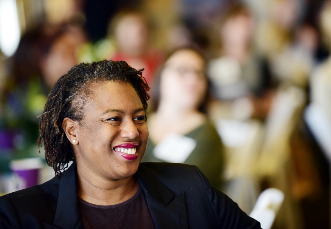 Woman smiling in front of audience