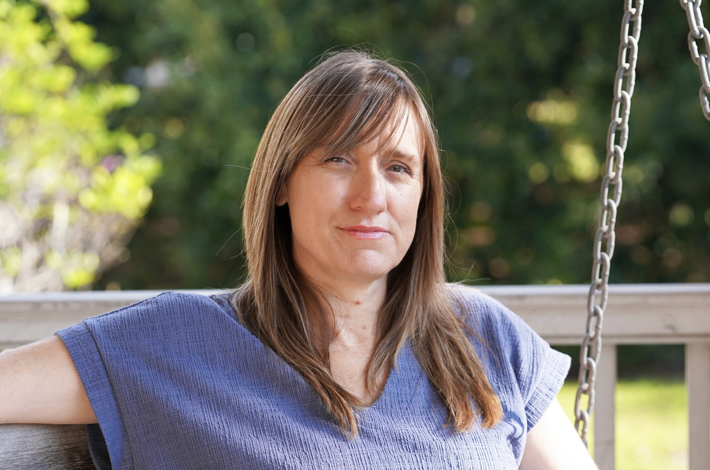 Heather Cooper headshot on porch swing
