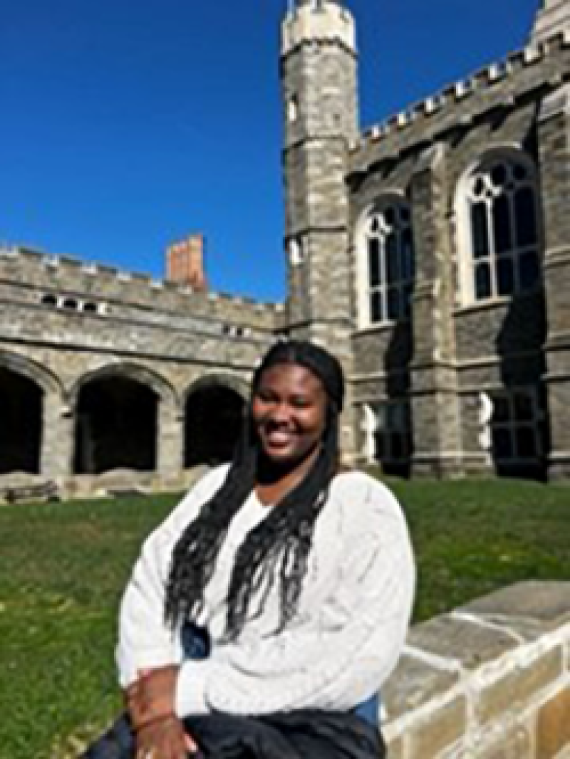 Gabby Evans Female student standing in front of castle