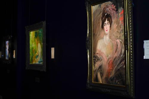 A row of paintings within M.S. Rau's fine art gallery.